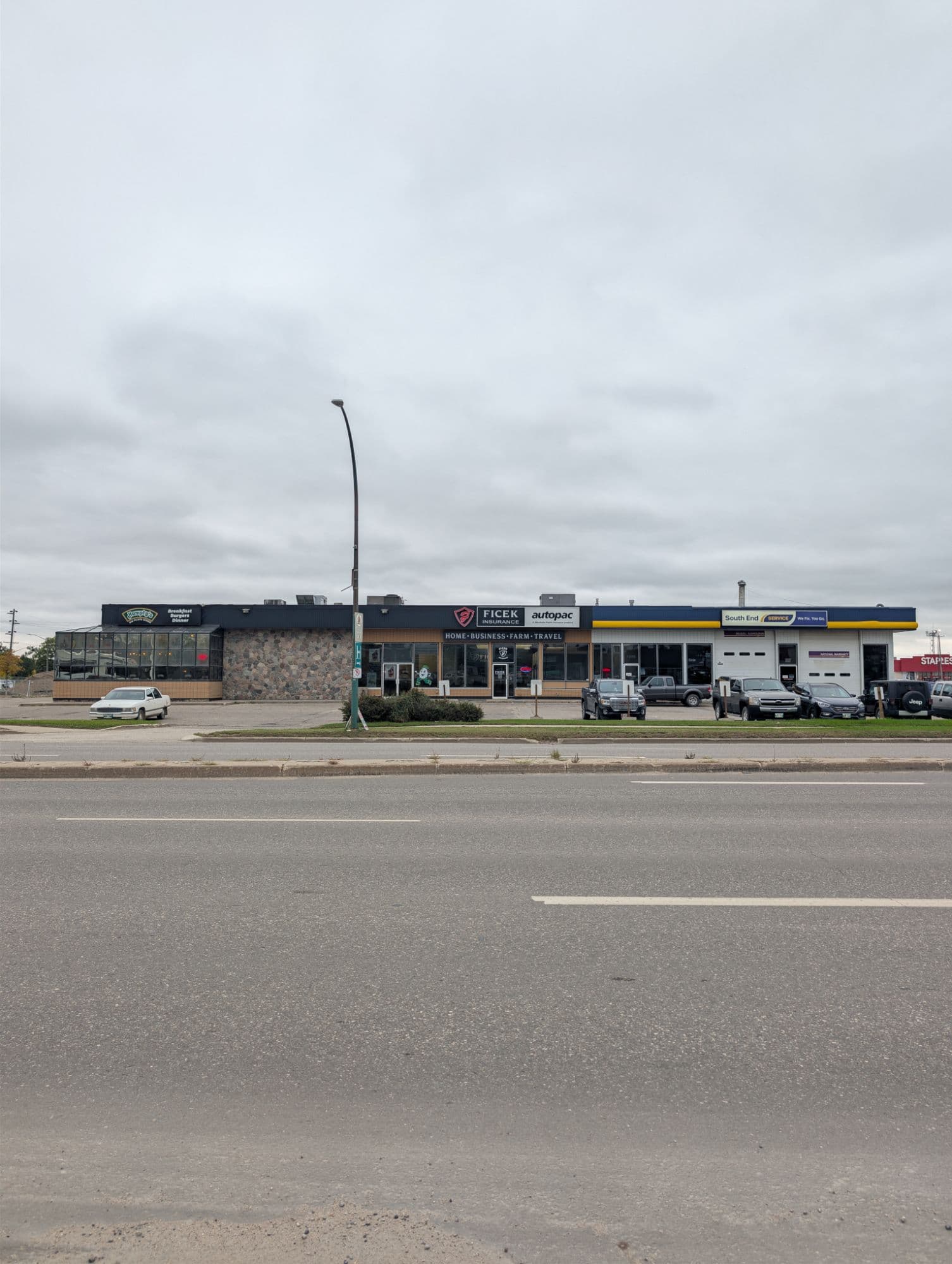 The strip on 18th Street in Brandon seen from across the road: Humpty’s on the left, Ficek Insurance and Autopac in the middle, and South End Service on the right.