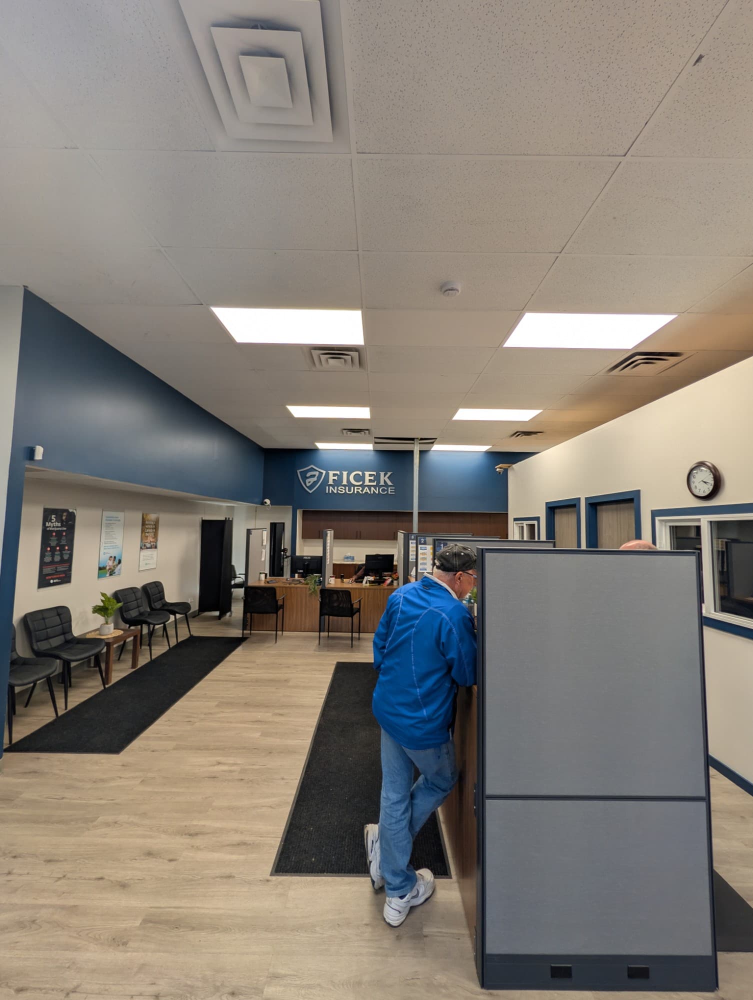 The 18th Street office interior looking toward the seating area, with chairs along the wall beside the service counters.