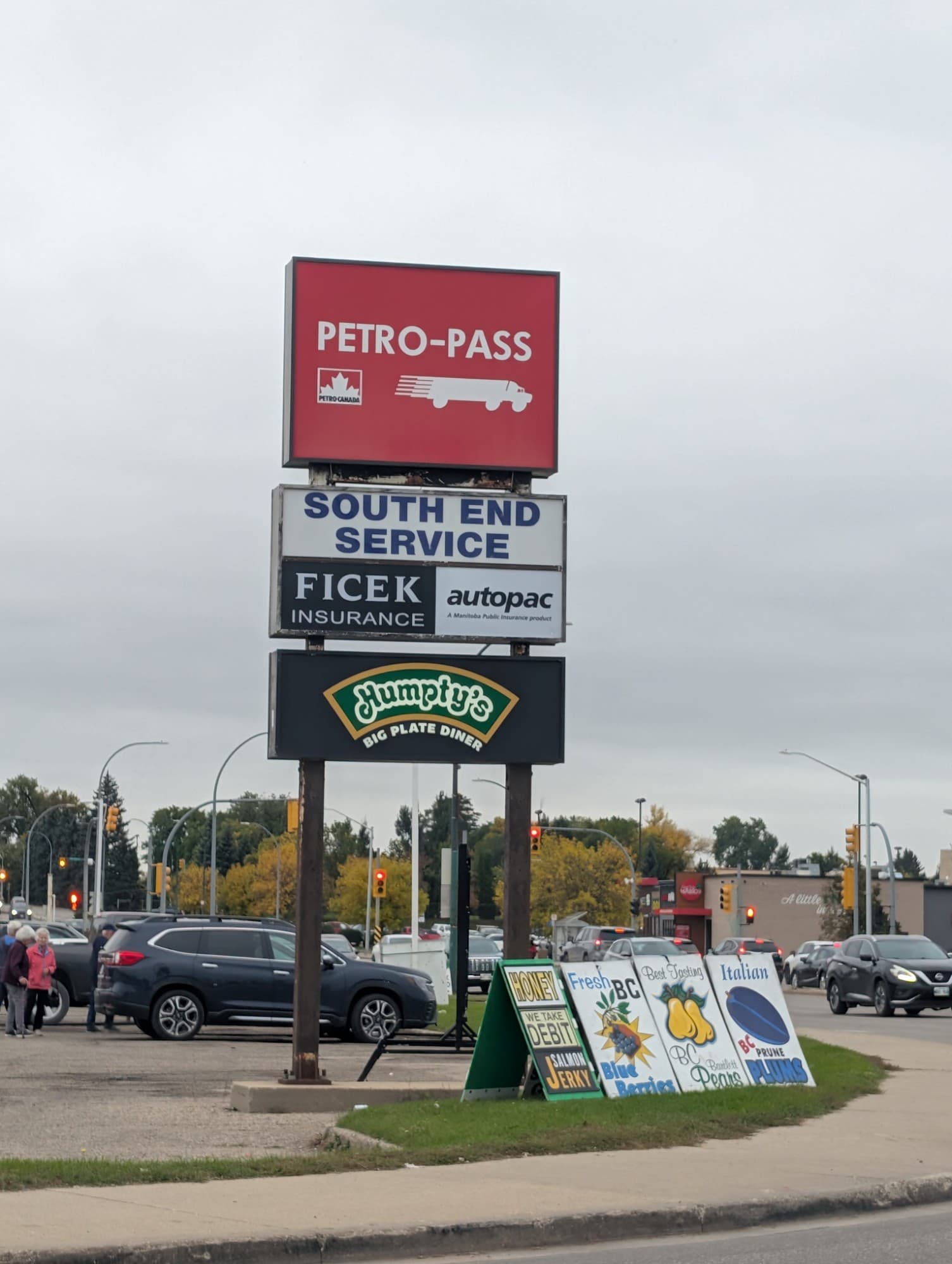 The tall roadside sign on 18th Street listing Petro-Pass, South End Service, Ficek Insurance with Autopac, and Humpty’s Big Plate Diner.