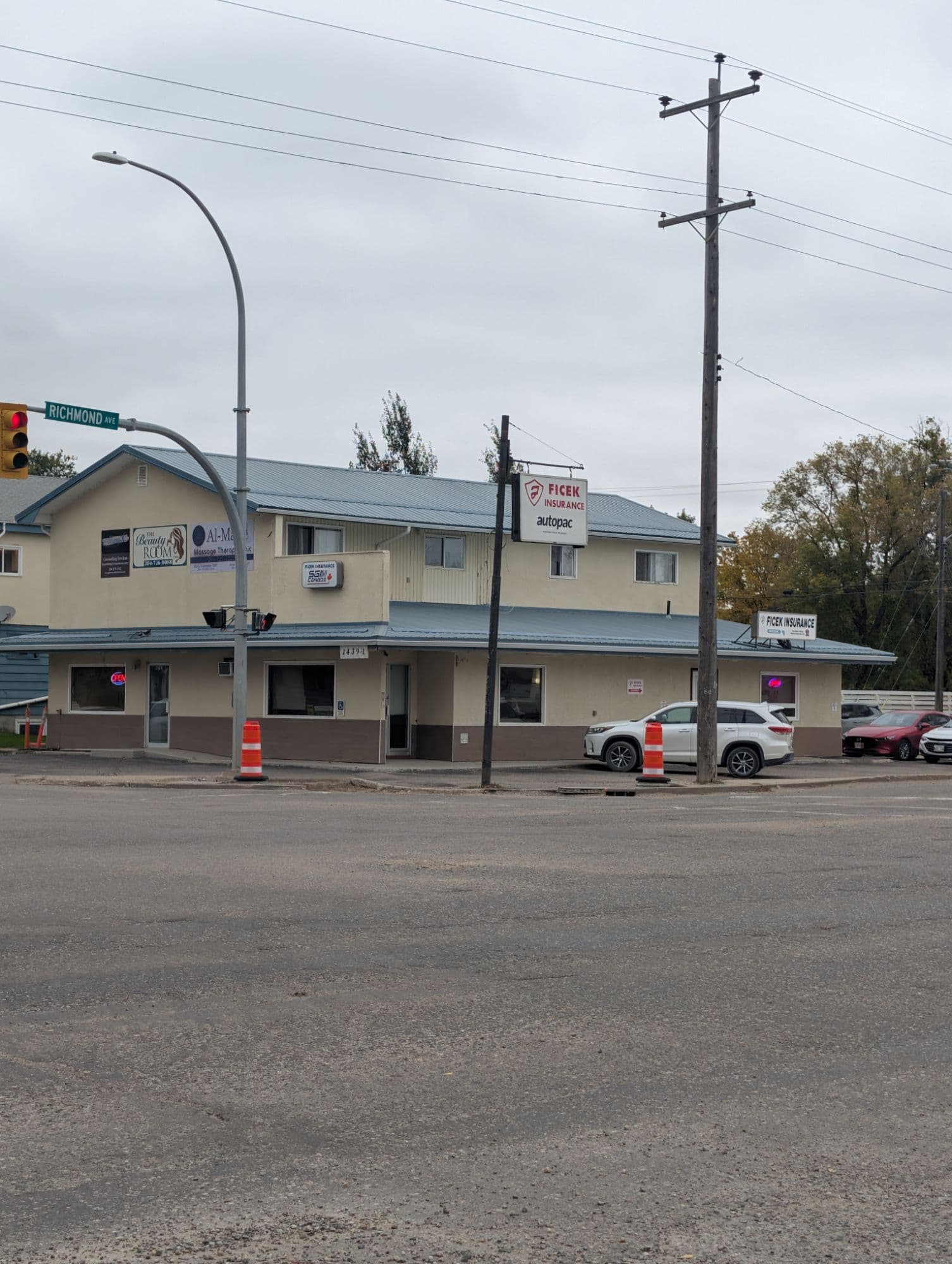 The Ficek Insurance building at 1439 1st Street, Brandon, seen from the Richmond Avenue corner, with the Ficek Insurance and Autopac sign on a post at the street.